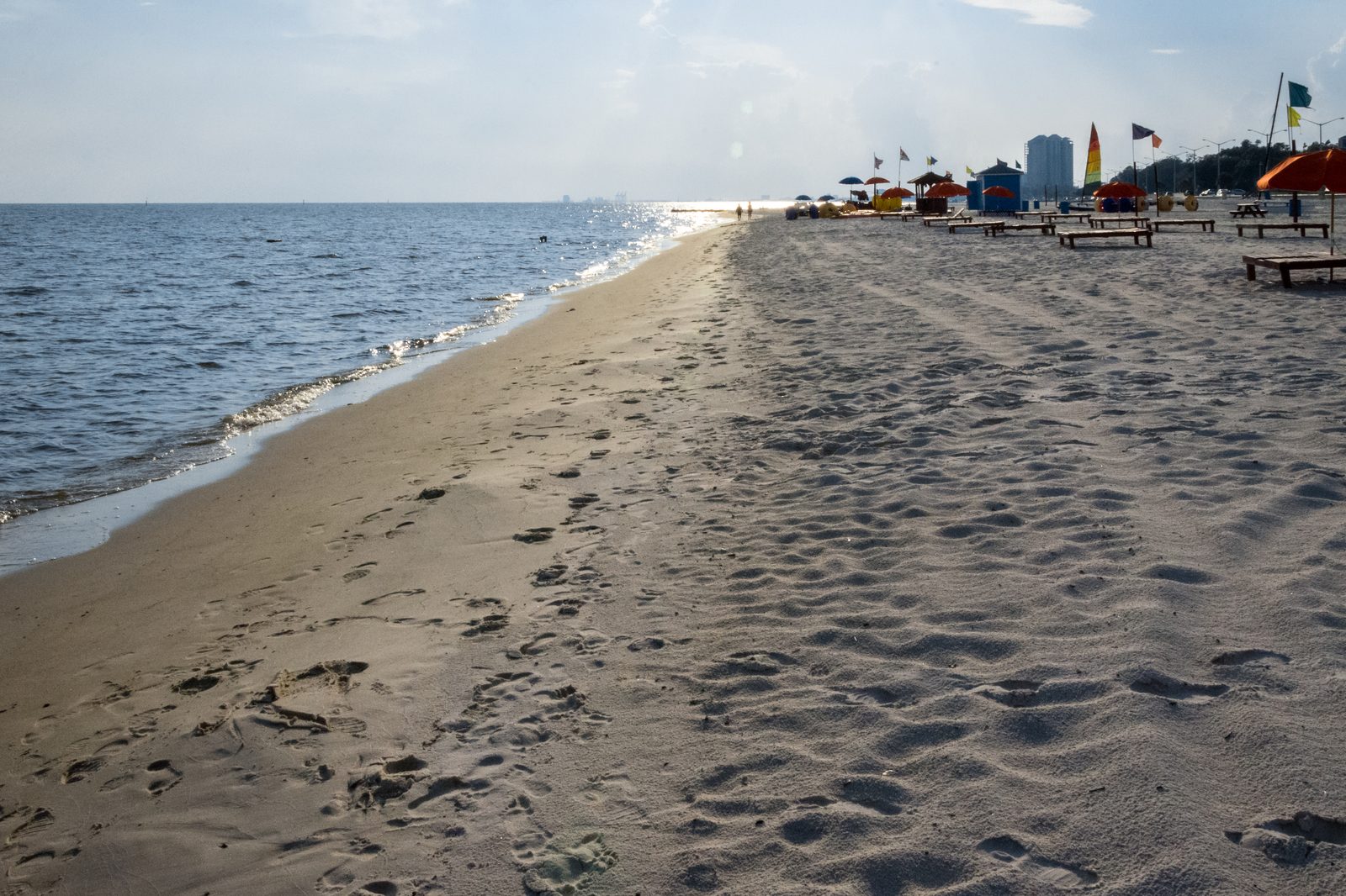 A quiet morning on Biloxi's beach with rental umbrellas set up along the sand