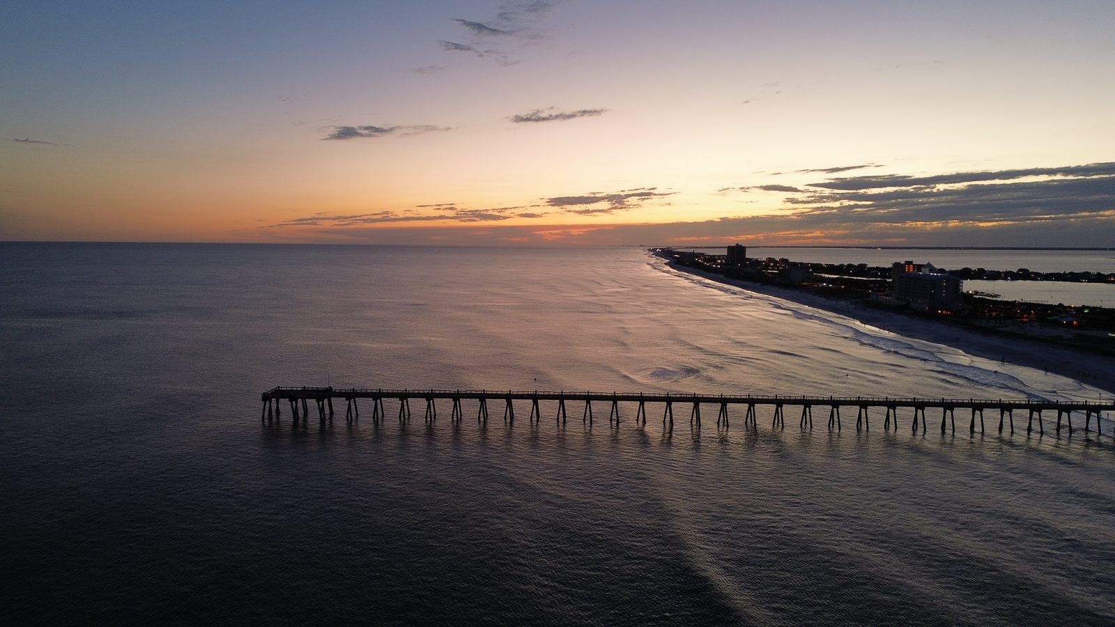Aerial view of the Pensacola Beach Gulf Pier at sunset